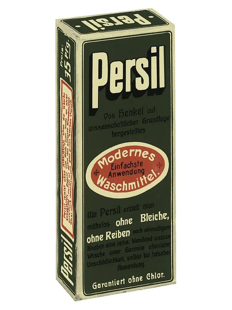 Caixa vintage de detergente Persil com texto em alemão e rótulo oval vermelho destacando a aplicação moderna e fácil.